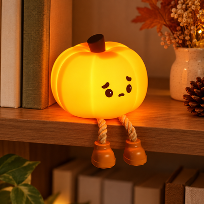 Pumpkin tap light with rope legs on a bookshelf